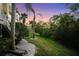 Landscaped backyard with a pathway, offering a tranquil outdoor space at 4338 Spinnaker Cove Ln, Tampa, FL 33615