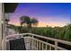 Spacious balcony overlooking lush landscaping and serene sunset views at 4338 Spinnaker Cove Ln, Tampa, FL 33615