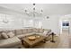 Open living room with sectional sofa and chandelier at 4338 Spinnaker Cove Ln, Tampa, FL 33615