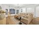 Spacious living room featuring a large sectional sofa and a statement chandelier at 4338 Spinnaker Cove Ln, Tampa, FL 33615