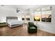 Spacious main bedroom with hardwood floors, a king-size bed, and large windows at 4338 Spinnaker Cove Ln, Tampa, FL 33615