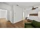 Main bedroom with king-size bed, hardwood floors, and access to another room at 4338 Spinnaker Cove Ln, Tampa, FL 33615
