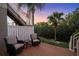 Cozy patio with wicker chairs and a small table, overlooking the garden at 4338 Spinnaker Cove Ln, Tampa, FL 33615