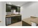 Well-equipped wet bar with dark cabinetry and granite at 4338 Spinnaker Cove Ln, Tampa, FL 33615