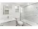 Elegant bathroom featuring a glass-enclosed shower with marble tile surround, a toilet and a sink at 801 83Rd N Ave # 120, St Petersburg, FL 33702
