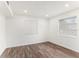Bright bedroom featuring wood-look floors, white walls, and two windows providing natural light at 801 83Rd N Ave # 120, St Petersburg, FL 33702