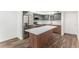 Modern kitchen with stainless steel appliances, white quartz countertops, and a stylish island at 801 83Rd N Ave # 120, St Petersburg, FL 33702