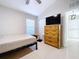 Bedroom with dresser and large TV at 8109 N Edison Ave, Tampa, FL 33604