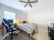 Bright bedroom featuring a bed, desk, and ceiling fan at 8109 N Edison Ave, Tampa, FL 33604
