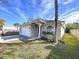 Tan house with a white garage door, and a palm tree in the front yard at 8109 N Edison Ave, Tampa, FL 33604