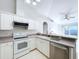 Open kitchen with stainless steel appliances and white cabinets at 8109 N Edison Ave, Tampa, FL 33604