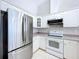Kitchen boasts stainless steel appliances and white cabinets at 8109 N Edison Ave, Tampa, FL 33604