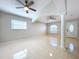 Open living room with tile floors and two ceiling fans at 8109 N Edison Ave, Tampa, FL 33604
