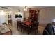 Bright dining room with wood table and chairs, and view into kitchen at 12300 Vonn Rd # 6103, Largo, FL 33774
