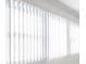 Interior shot of a window with white vertical blinds, offering privacy and light control at 1239 S Martin Luther King Jr Ave # 104, Clearwater, FL 33756