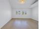 Bright bedroom with vaulted ceilings, shiplap walls, and hardwood floors at 1355 Pinellas Bayway S # 23, Tierra Verde, FL 33715