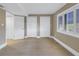 Empty bedroom with light walls and wood flooring, featuring ample closet space at 1355 Pinellas Bayway S # 23, Tierra Verde, FL 33715