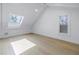 Bright bedroom with vaulted ceiling, skylight, and wood flooring at 1355 Pinellas Bayway S # 23, Tierra Verde, FL 33715