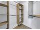 Spacious walk-in closet with custom built-in shelving and hanging rods at 1355 Pinellas Bayway S # 23, Tierra Verde, FL 33715