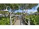 Wooden community dock with walkway to the water at 1355 Pinellas Bayway S # 23, Tierra Verde, FL 33715
