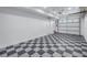 Bright garage with checkerboard floor and ample storage space at 1355 Pinellas Bayway S # 23, Tierra Verde, FL 33715