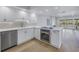 Modern white kitchen with stainless steel appliances and quartz countertops at 1355 Pinellas Bayway S # 23, Tierra Verde, FL 33715