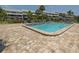 Community pool with surrounding lounge chairs at 1355 Pinellas Bayway S # 23, Tierra Verde, FL 33715