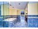 Elegant bathroom with blue tile, a large tub, and granite vanity at 13635 Twin Lakes Ln # 13635, Tampa, FL 33618
