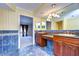 Double vanity bathroom with granite countertops and blue tile floors at 13635 Twin Lakes Ln # 13635, Tampa, FL 33618