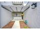 Covered entryway with hanging plants and tiled flooring at 13635 Twin Lakes Ln # 13635, Tampa, FL 33618