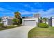 Gray townhome with attached garage and lush landscaping at 13635 Twin Lakes Ln # 13635, Tampa, FL 33618