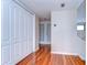 Hallway with hardwood floors, white doors, and access to upper level at 13635 Twin Lakes Ln # 13635, Tampa, FL 33618