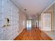 Bright hallway with hardwood floors and access to other rooms at 13635 Twin Lakes Ln # 13635, Tampa, FL 33618