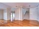 Elegant hallway with hardwood floors, white columns, and staircase leading upstairs at 13635 Twin Lakes Ln # 13635, Tampa, FL 33618