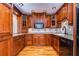 Kitchen with wood cabinets, granite counters and stainless steel appliances at 13635 Twin Lakes Ln # 13635, Tampa, FL 33618