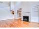 Spacious living room featuring hardwood floors, fireplace, and view to upper level at 13635 Twin Lakes Ln # 13635, Tampa, FL 33618