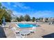 Community pool with lounge chairs and patio at 13635 Twin Lakes Ln # 13635, Tampa, FL 33618