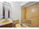 Bathroom featuring a tiled walk-in shower, yellow toilet and sink with vanity at 22368 Southshore Dr, Land O Lakes, FL 34639