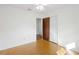 A clean bedroom shows wood-look floors, a closet, and doorway to another room at 22368 Southshore Dr, Land O Lakes, FL 34639