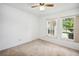 Bright bedroom with carpet and two windows with views to the yard at 22368 Southshore Dr, Land O Lakes, FL 34639