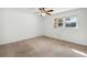 Bedroom with carpet, a ceiling fan, and window, providing ample natural light at 22368 Southshore Dr, Land O Lakes, FL 34639