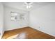 Bright bedroom featuring wood-look floors and a window for natural light at 22368 Southshore Dr, Land O Lakes, FL 34639