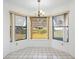 Bright breakfast nook featuring tile flooring, a chandelier, and backyard views at 22368 Southshore Dr, Land O Lakes, FL 34639