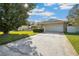 Inviting home with a well-manicured lawn, a two-car garage, and stone accents on the facade at 22368 Southshore Dr, Land O Lakes, FL 34639