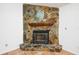 Close-up of stone fireplace with wood mantle and tile hearth at 22368 Southshore Dr, Land O Lakes, FL 34639