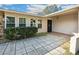 Welcoming front entrance with a covered patio and a decorative stone walkway, offering curb appeal at 22368 Southshore Dr, Land O Lakes, FL 34639