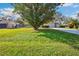 Charming home with a well-kept front yard, mature trees, and an attached two-car garage at 22368 Southshore Dr, Land O Lakes, FL 34639