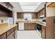 Traditional kitchen features wood cabinets, tile flooring, and an overhead skylight at 22368 Southshore Dr, Land O Lakes, FL 34639
