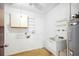 Functional laundry room with a utility sink, shelving, and a water heater at 22368 Southshore Dr, Land O Lakes, FL 34639