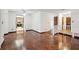 Bright living room with parquet flooring, white walls and views to the kitchen and entry at 22368 Southshore Dr, Land O Lakes, FL 34639